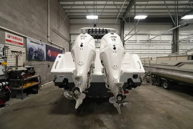 Slide: The Image of Two powerful outboard engines are mounted on a boat in a warehouse, surrounded by workshop tools. - 2