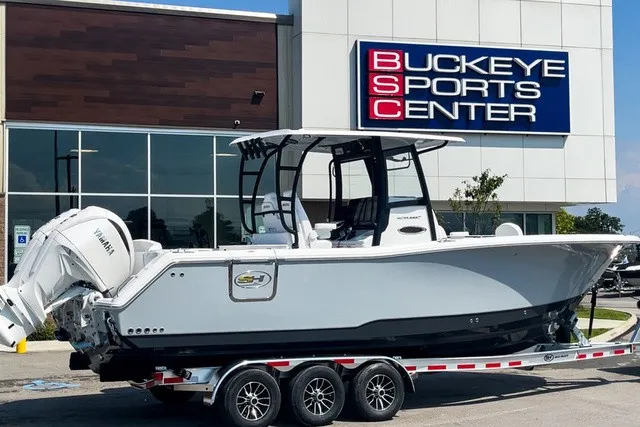 The Image of A 2027 Sea Hunt Ultra 285SE boat on a trailer outside a sports center. - 0