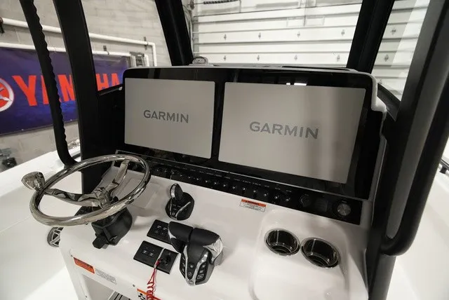 Slide: The Image of The 2027 Sea Hunt Ultra 285SE cockpit features two large Garmin screens and a sleek steering wheel. - 12