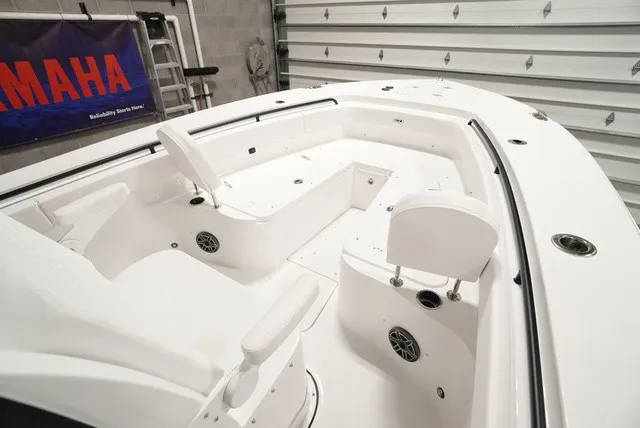 Slide: The Image of The image shows the deck of a 2027 Sea Hunt Ultra 285SE boat with white seating. - 14