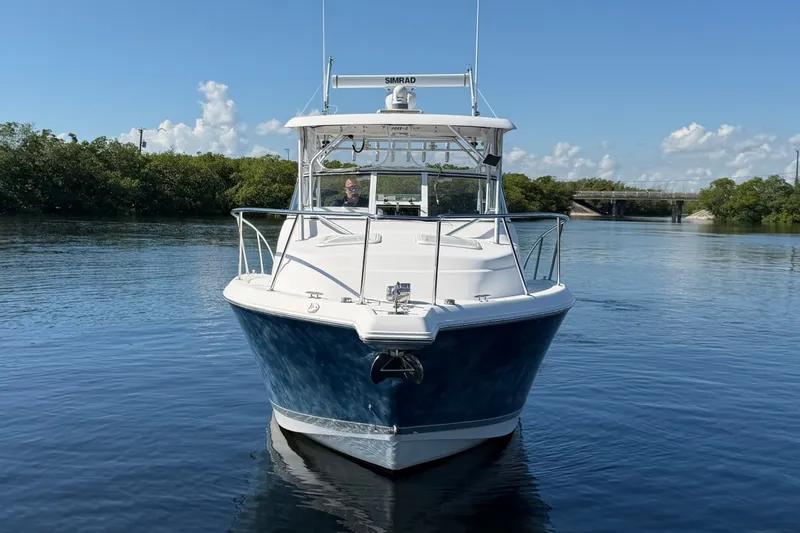 Slide: The Image of 2008 Pro-Line 32 Express boat on calm water, clear sky background. - 5