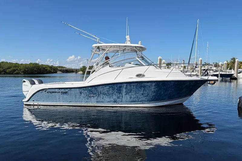 Slide: The Image of 2008 Pro-Line 32 Express boat docked in a marina under clear blue skies. - 4