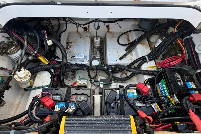 Slide: The Image of Engine compartment of a 2008 Pro-Line 32 Express boat with batteries and wiring. - 27