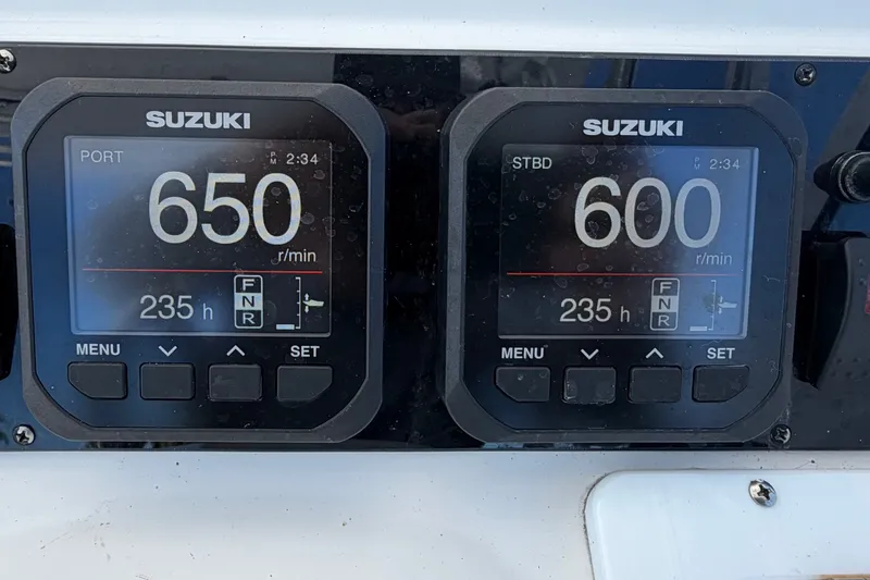 Slide: The Image of Digital displays on a 2008 Pro-Line 32 Express boat showing engine RPM and hours. - 18