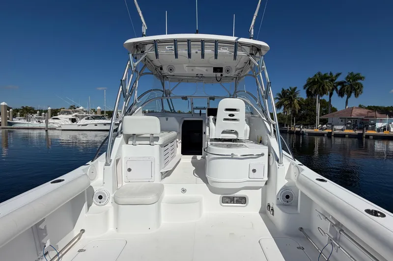 Slide: The Image of 2008 Pro-Line 32 Express boat interior, docked at marina with clear blue sky. - 12