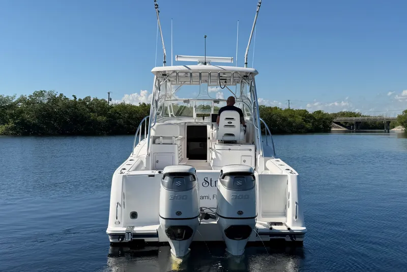 Slide: The Image of 2008 Pro-Line 32 Express boat with dual Suzuki engines on calm water. - 6