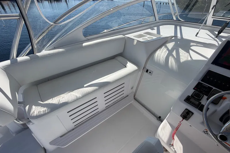 Slide: The Image of 2008 Pro-Line 32 Express boat interior with white seating and control panel. - 15