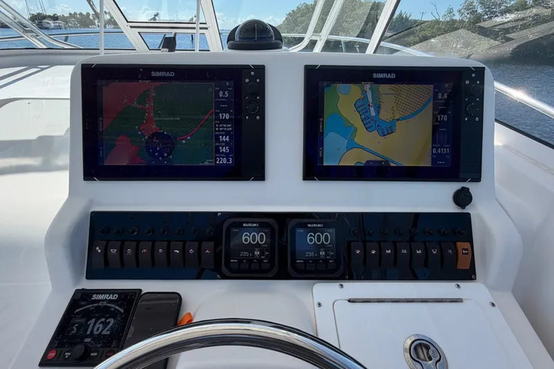 Slide: The Image of Helm of 2008 Pro-Line 32 Express boat with dual Simrad navigation displays. - 19