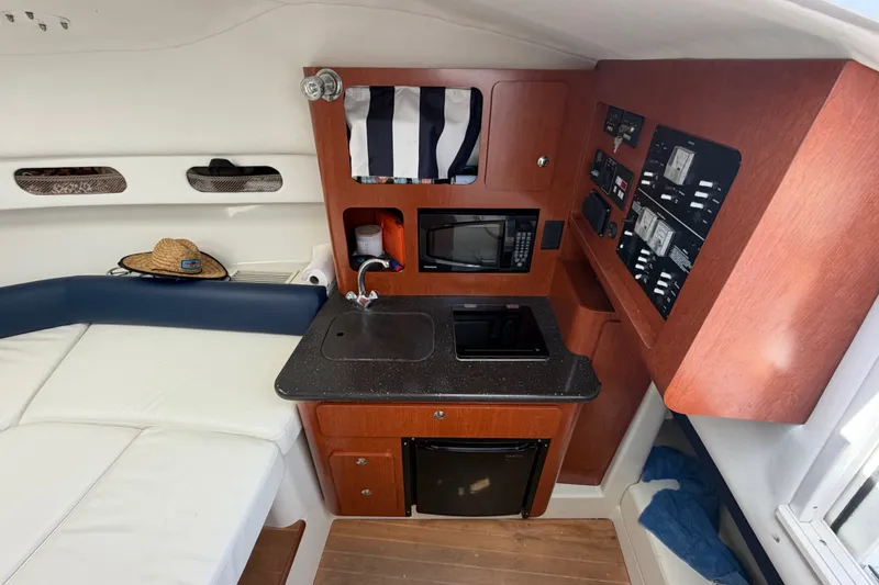 Slide: The Image of 2008 Pro-Line 32 Express cabin interior with kitchenette, sink, and control panel. - 29