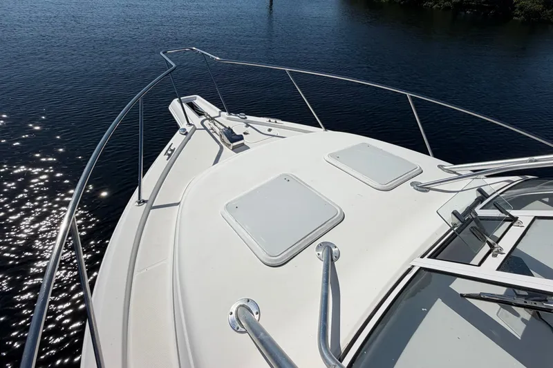 Slide: The Image of 2008 Pro-Line 32 Express boat deck with railing, on calm water. - 25