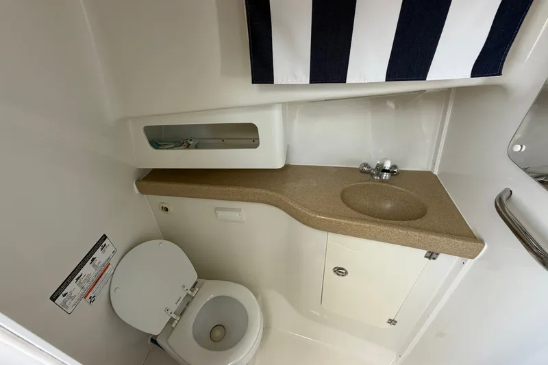 Slide: The Image of 2008 Pro-Line 32 Express boat bathroom with toilet, sink, and storage. - 32