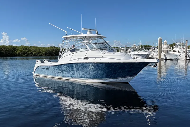 Slide: The Image of 2008 Pro-Line 32 Express boat on calm water, clear sky background. - 3