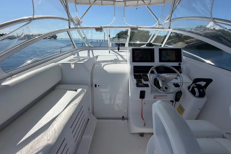 Slide: The Image of 2008 Pro-Line 32 Express boat interior with helm, steering wheel, and navigation screens. - 17