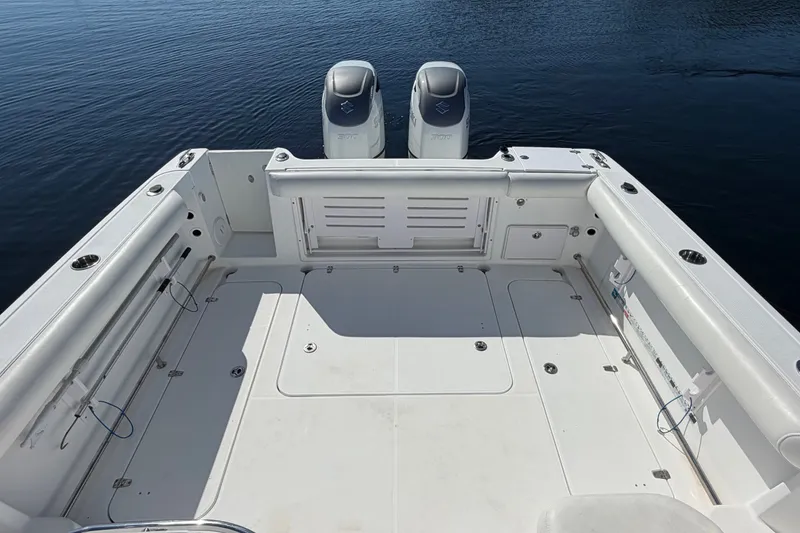 Slide: The Image of 2008 Pro-Line 32 Express boat deck with twin engines on calm water. - 10