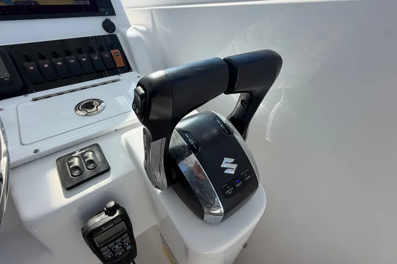 Slide: The Image of Control panel of a 2008 Pro-Line 32 Express boat with throttle and communication device. - 20