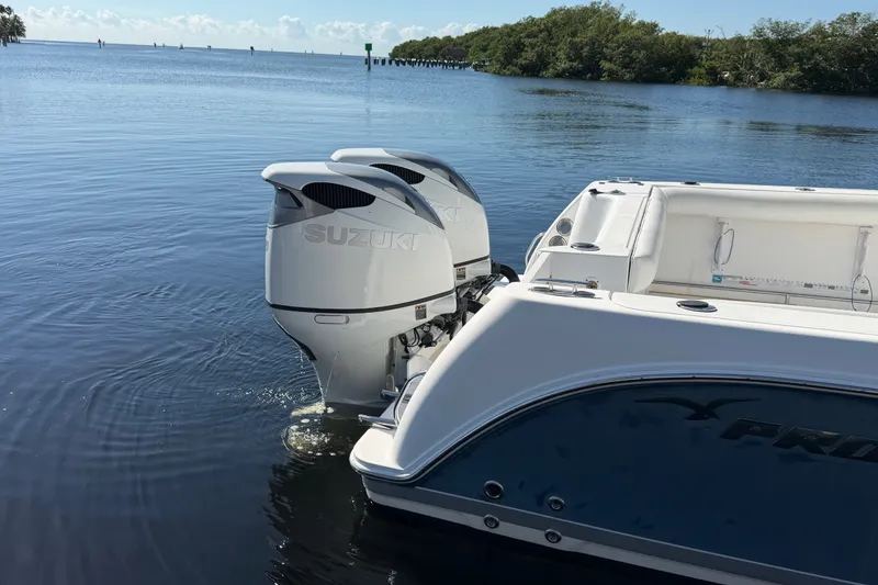 Slide: The Image of 2008 Pro-Line 32 Express boat with Suzuki outboard motors on calm water. - 7