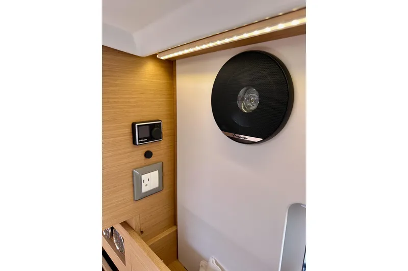 Slide: The Image of Interior of 2024 Jeanneau Sun Odyssey 410 with speaker and control panel. - 78