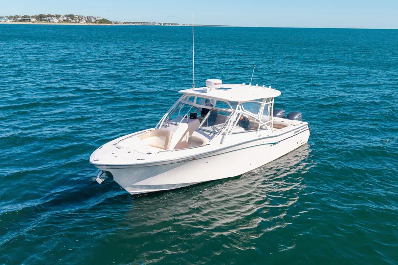 Slide: The Image of 2014 Grady-White Freedom 307 boat cruising on open blue water. - 45