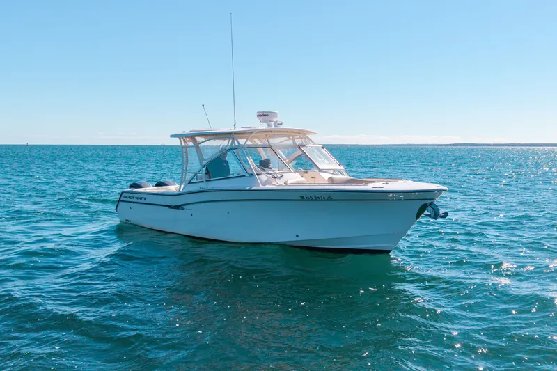 Slide: The Image of 2014 Grady-White Freedom 307 boat on open water under clear blue sky. - 43