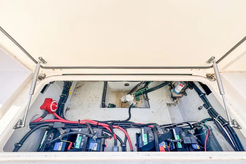 Slide: The Image of 2014 Grady-White Freedom 307 boat battery compartment with wiring and components. - 35