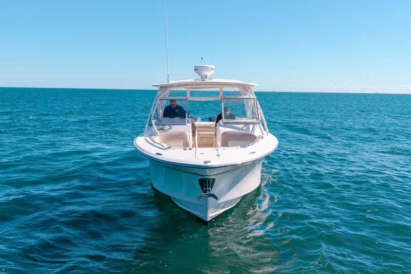 Slide: The Image of 2014 Grady-White Freedom 307 boat cruising on open blue sea. - 42