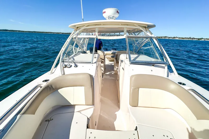 Slide: The Image of 2014 Grady-White Freedom 307 boat cruising on open water, showcasing spacious seating and sleek design. - 21