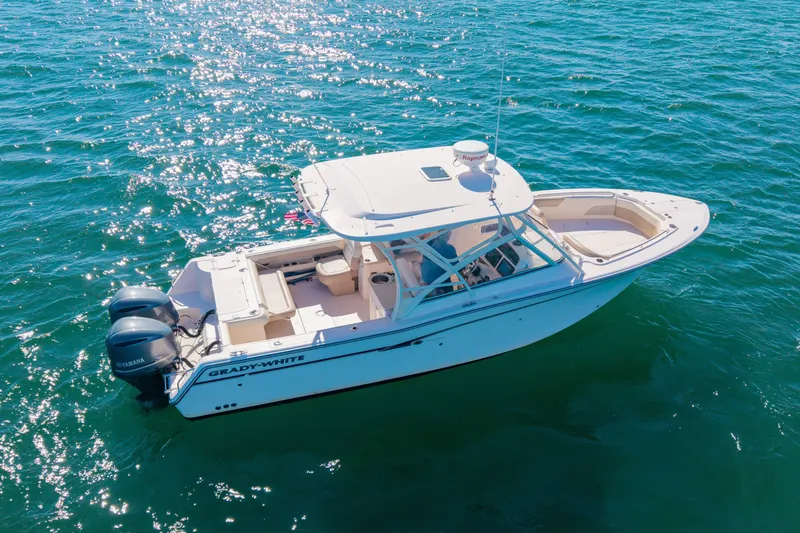 Slide: The Image of 2014 Grady-White Freedom 307 boat on sparkling blue water. - 52