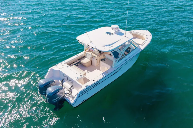 Slide: The Image of 2014 Grady-White Freedom 307 boat on clear blue water, featuring twin Yamaha engines. - 51