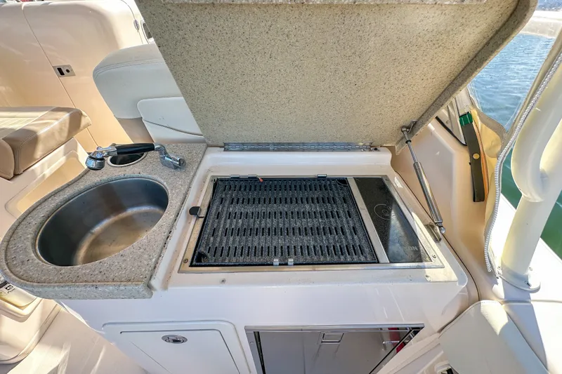 Slide: The Image of Outdoor kitchen on 2014 Grady-White Freedom 307 boat with sink and grill. - 27
