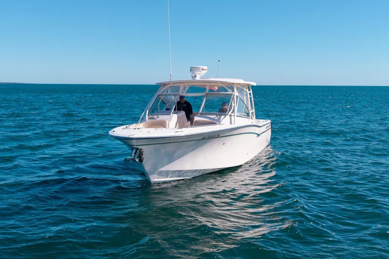 Slide: The Image of 2014 Grady-White Freedom 307 boat cruising on open blue water. - 44