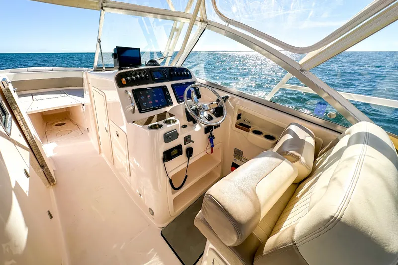 Slide: The Image of Interior of 2014 Grady-White Freedom 307 boat with ocean view and modern controls. - 16