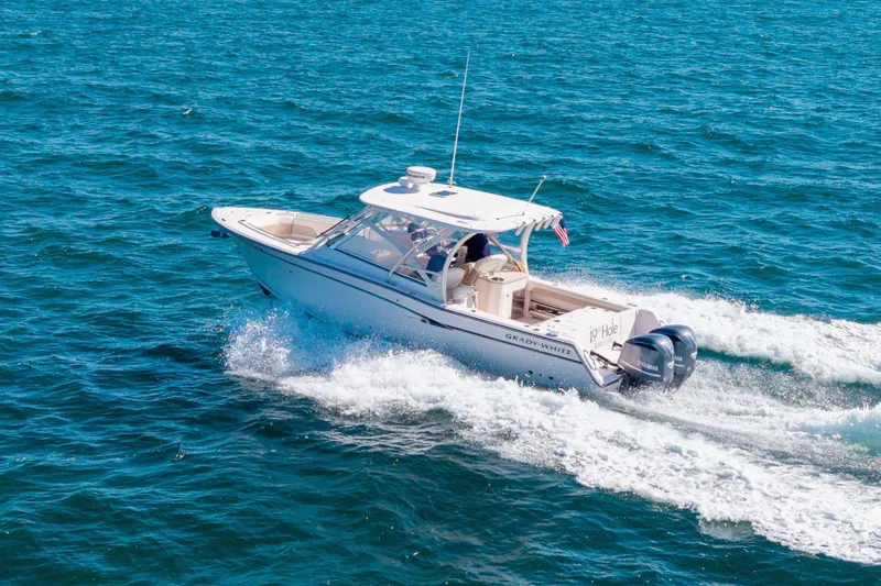 Slide: The Image of 2014 Grady-White Freedom 307 boat cruising on open blue water. - 7