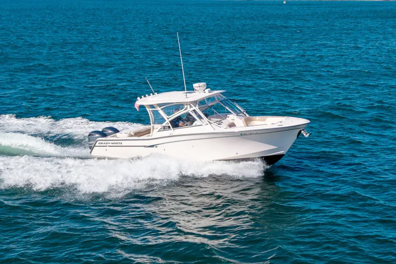 Slide: The Image of 2014 Grady-White Freedom 307 boat cruising on open blue water. - 5