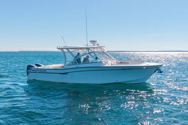 Slide: The Image of 2014 Grady-White Freedom 307 boat cruising on open water under clear skies. - 41