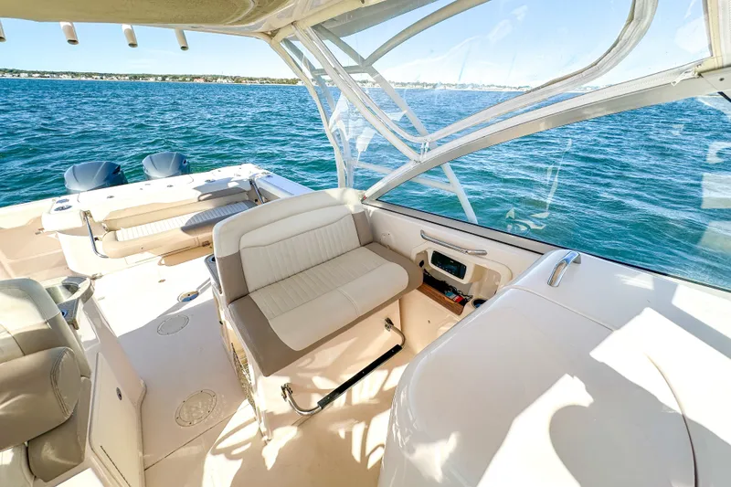 Slide: The Image of 2014 Grady-White Freedom 307 boat interior with seating, on a sunny day at sea. - 31