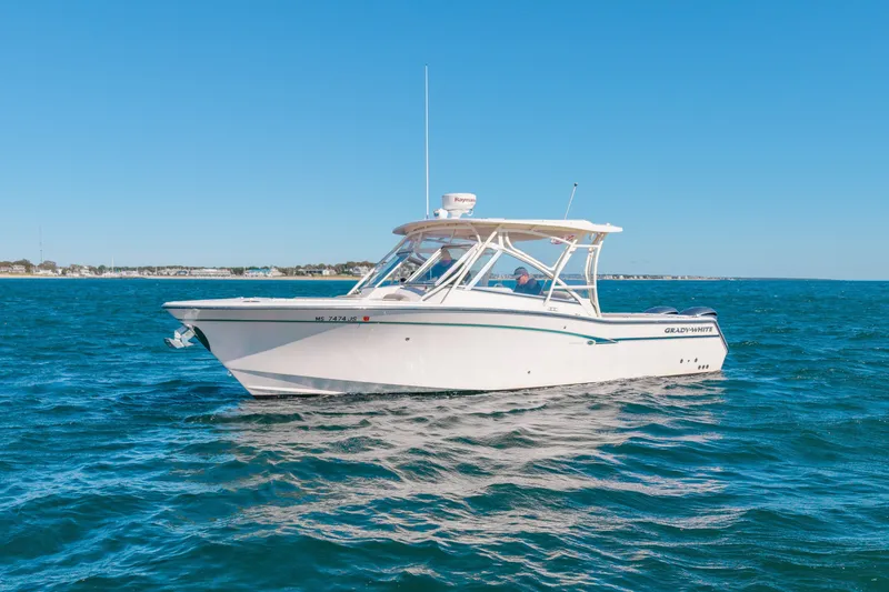 The Image of 2014 Grady-White Freedom 307 boat cruising on open water under clear blue skies. - 0