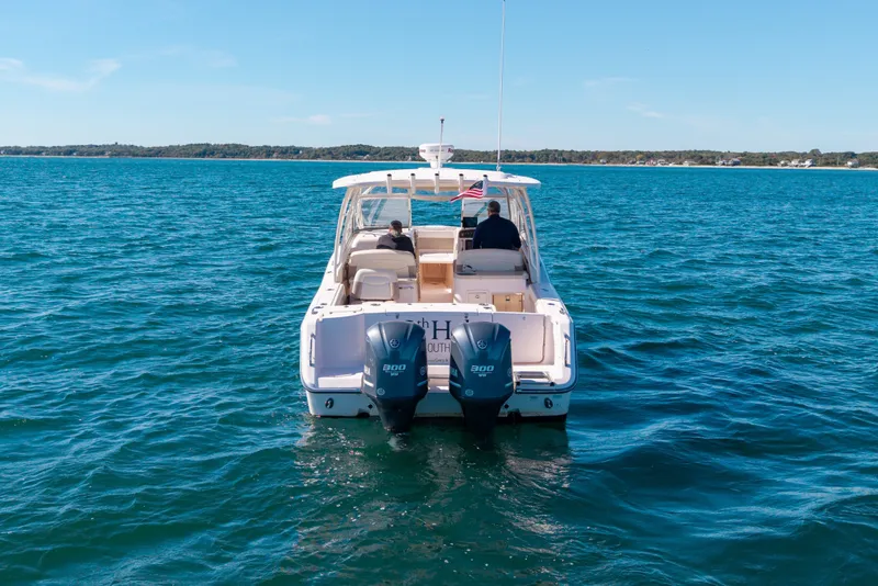 Slide: The Image of 2014 Grady-White Freedom 307 boat cruising on open water, rear view. - 14