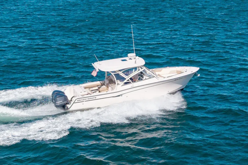 Slide: The Image of 2014 Grady-White Freedom 307 boat cruising on open blue water. - 2