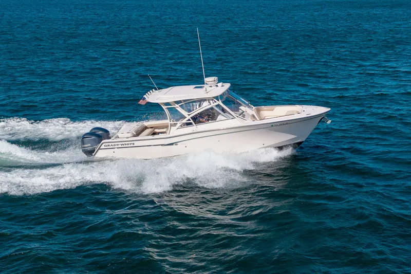 Slide: The Image of 2014 Grady-White Freedom 307 boat cruising on open blue water. - 3