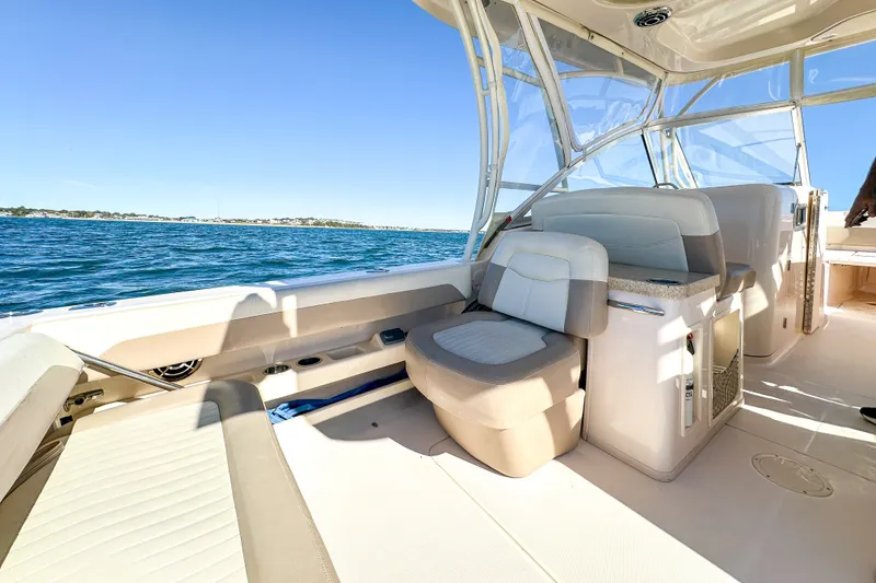 Slide: The Image of 2014 Grady-White Freedom 307 boat interior with seating, on a sunny day at sea. - 25