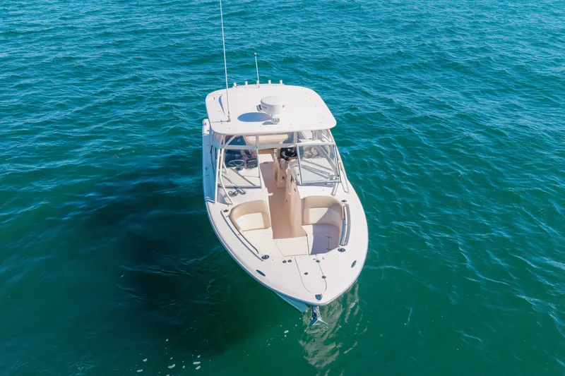 Slide: The Image of 2014 Grady-White Freedom 307 boat on clear blue water, aerial view. - 54