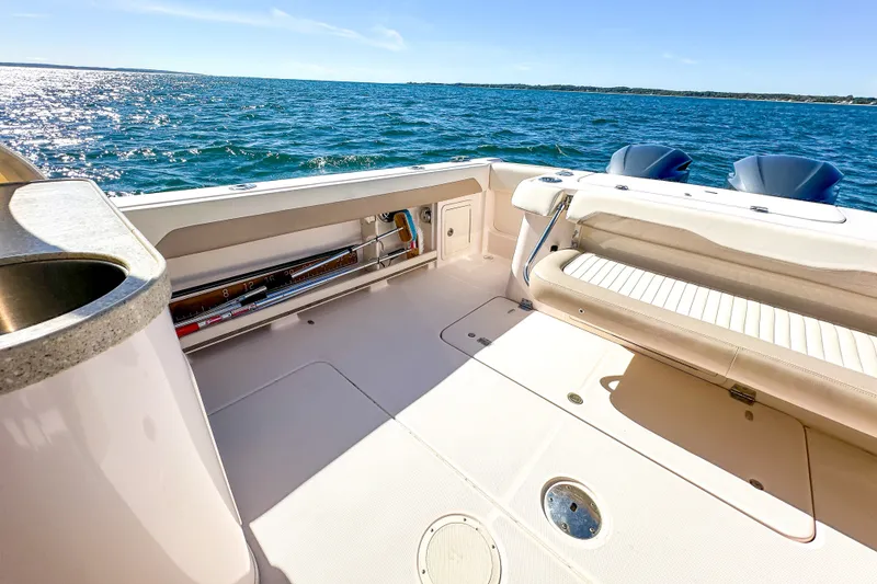 Slide: The Image of 2014 Grady-White Freedom 307 boat interior with ocean view, featuring seating and storage. - 23