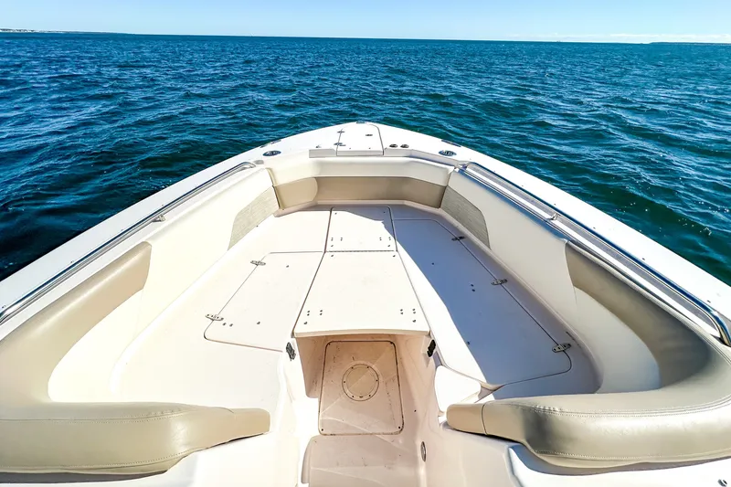 Slide: The Image of 2014 Grady-White Freedom 307 boat on open water, showcasing spacious seating area. - 20