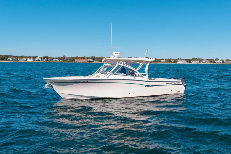 Slide: The Image of 2014 Grady-White Freedom 307 boat cruising on a sunny day. - 9