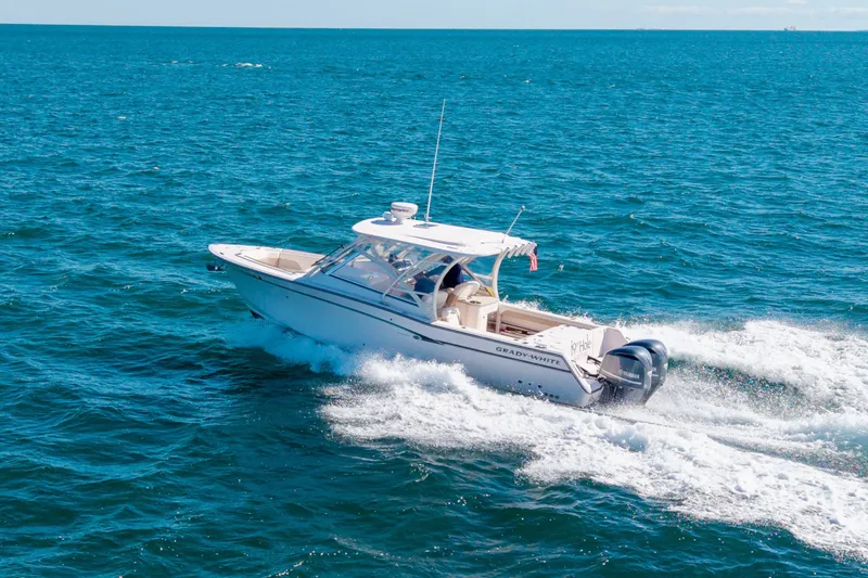 Slide: The Image of 2014 Grady-White Freedom 307 boat cruising on open blue ocean waters. - 6