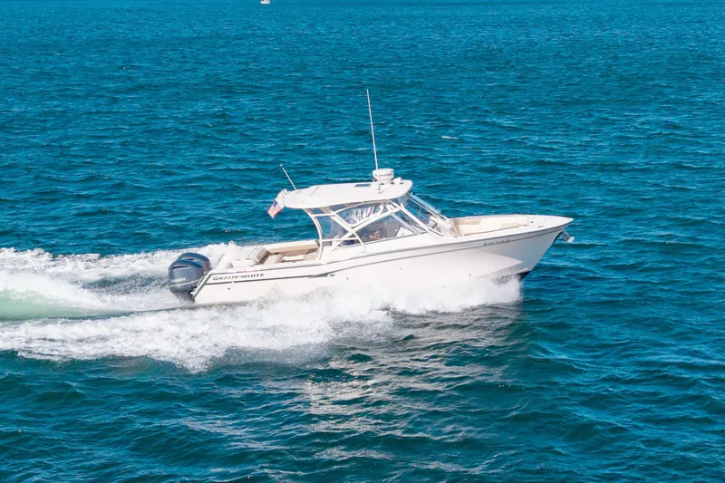 Slide: The Image of 2014 Grady-White Freedom 307 boat cruising on open blue water. - 1