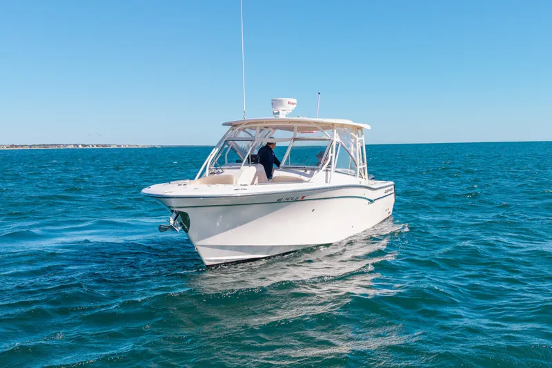 Slide: The Image of 2014 Grady-White Freedom 307 boat cruising on open blue water. - 12