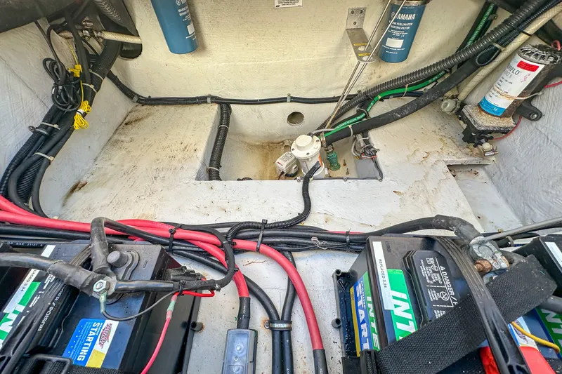 Slide: The Image of 2014 Grady-White Freedom 307 boat engine compartment with batteries and wiring. - 36