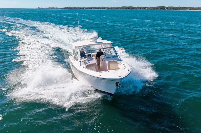 Slide: The Image of 2014 Grady-White Freedom 307 cruising on open blue waters. - 4