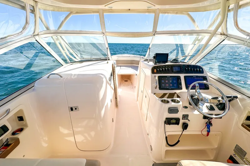 Slide: The Image of Interior view of 2014 Grady-White Freedom 307 boat, featuring helm and ocean backdrop. - 17